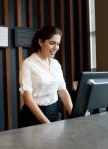 Person behind counter on computer