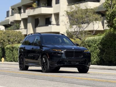 BMW X7 xDrive40i rental car parked on street